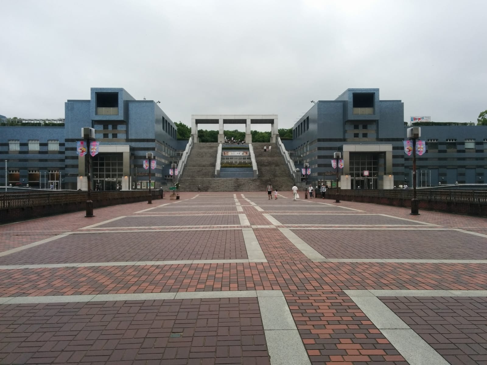 The wide paved boulevard to Parthenon Tama, lined with lamp posts carrying character flags