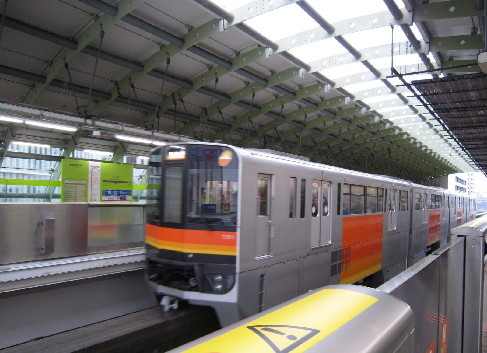 A Tama Monorail train arriving at the platform of Tachikawa-Kita Station