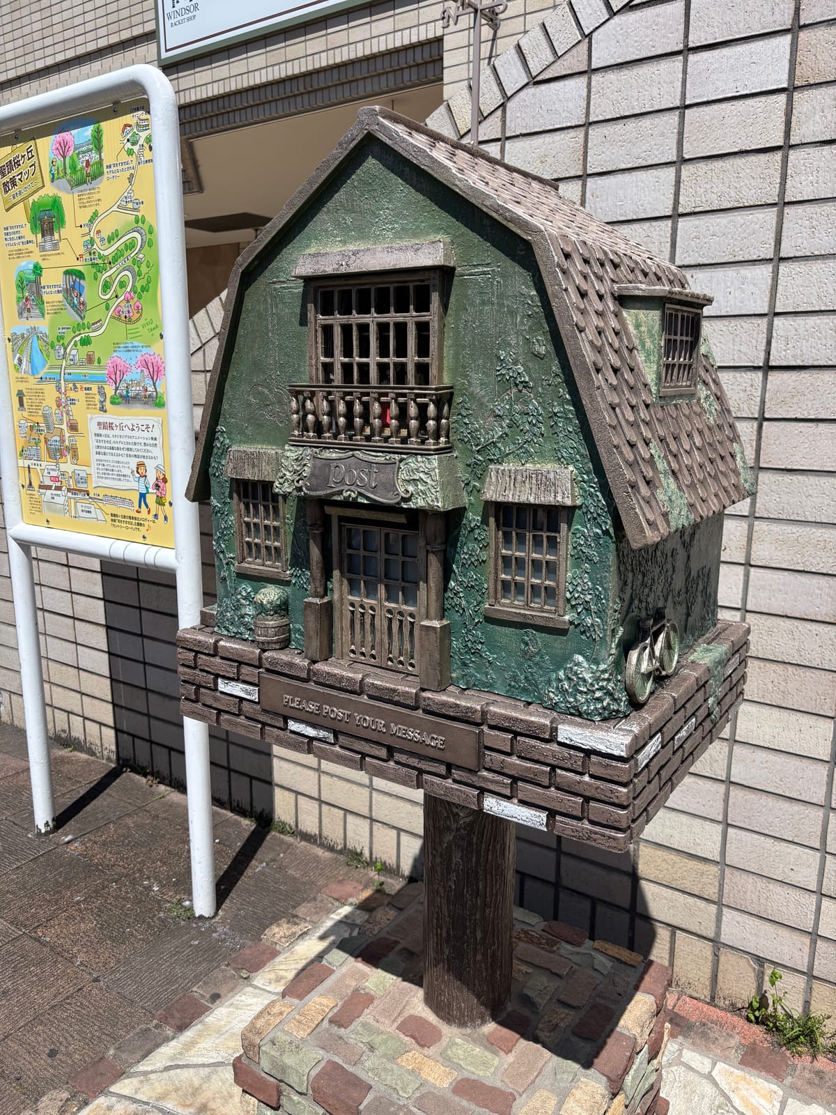 The Youth Post at the West Exit, with the Seiseki-sakuragaoka walking map board beside it